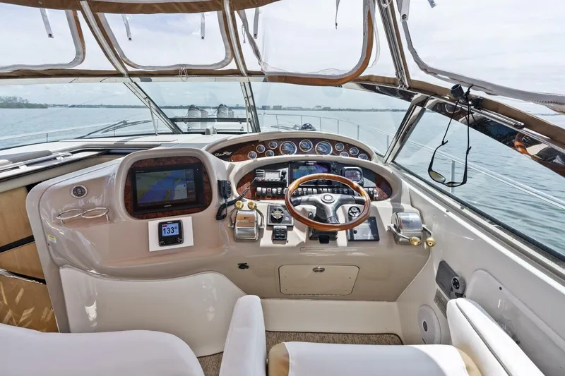 Slide: The Image of Cockpit of 2001 Sea Ray 380 Sundancer with steering wheel and navigation equipment. - 6