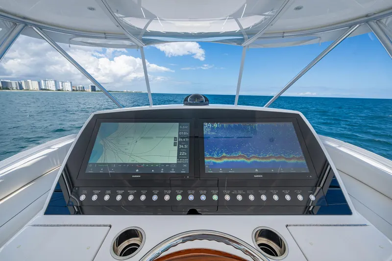 Slide: The Image of Helm of a Viking boat with dual navigation screens, overlooking ocean and coastline. - 11