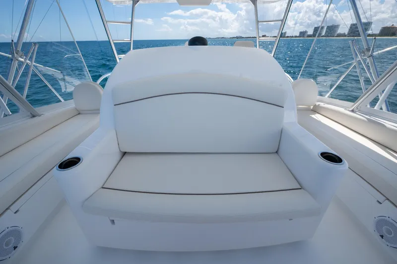 Slide: The Image of Luxury Viking yacht seating with ocean view, featuring white cushioned bench and cup holders. - 16