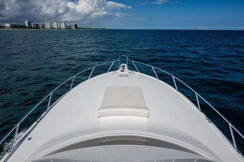 Slide: The Image of Bow of a Viking yacht cruising on open ocean with city skyline in background. - 18