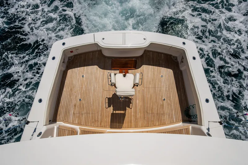 Slide: The Image of Viking yacht deck with wooden flooring and fishing chair, surrounded by ocean waves. - 23