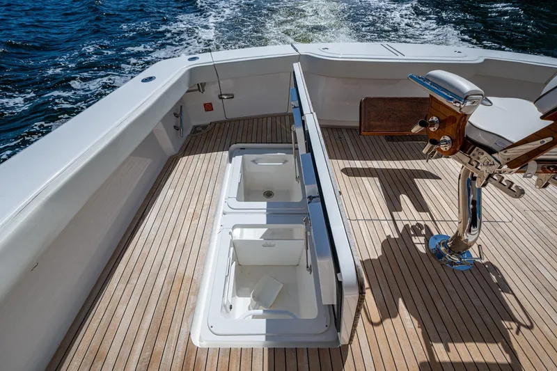 Slide: The Image of Viking boat deck with fishing chair and storage compartments on open water. - 26