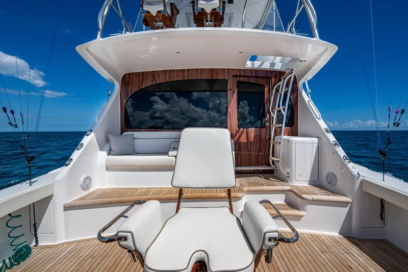 Slide: The Image of Luxurious Viking yacht deck with seating, ocean view, and fishing rods under clear blue sky. - 27