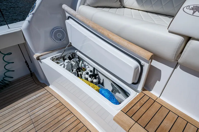 Slide: The Image of Open storage compartment on a Viking boat with cleaning supplies and ropes. - 32