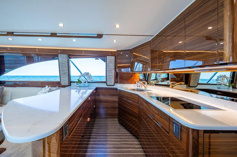Slide: The Image of Luxurious Viking yacht interior with sleek wood finishes and modern kitchen overlooking the ocean. - 37
