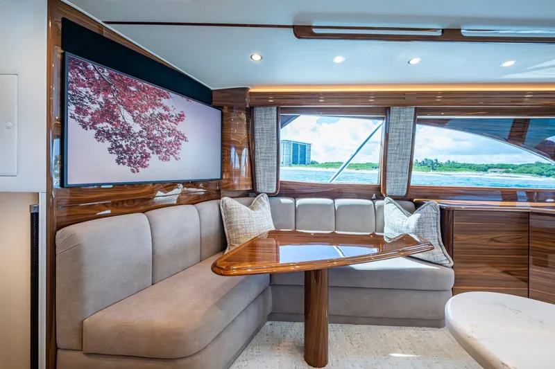 Slide: The Image of Luxurious Viking yacht interior with elegant seating, wooden accents, and scenic window view. - 42