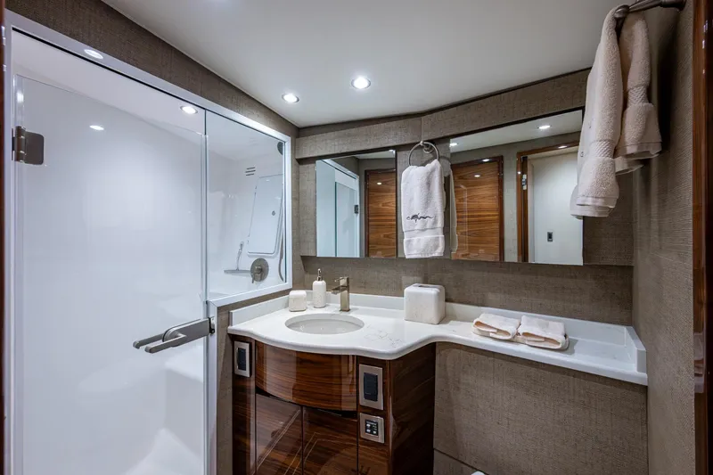 Slide: The Image of Luxurious Viking yacht bathroom with modern fixtures, elegant wood accents, and plush towels. - 48