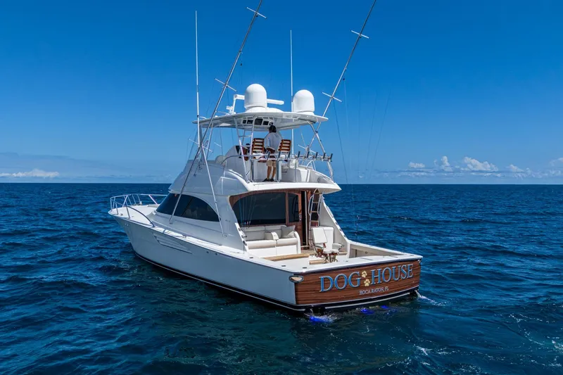 Slide: The Image of Luxury Viking yacht "Dog House" cruising on open ocean under clear blue sky. - 5