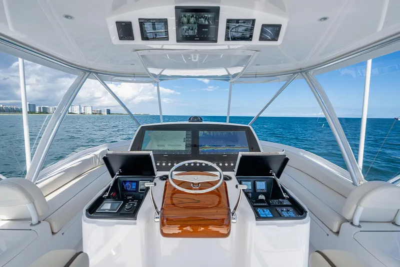 Slide: The Image of Luxurious Viking yacht helm with advanced navigation systems, overlooking ocean and city skyline. - 9