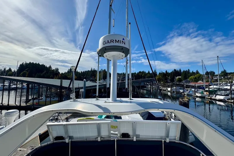 Slide: The Image of 1998 Bayliner 3388 Command Bridge Motoryacht docked at marina under clear blue sky. - 12
