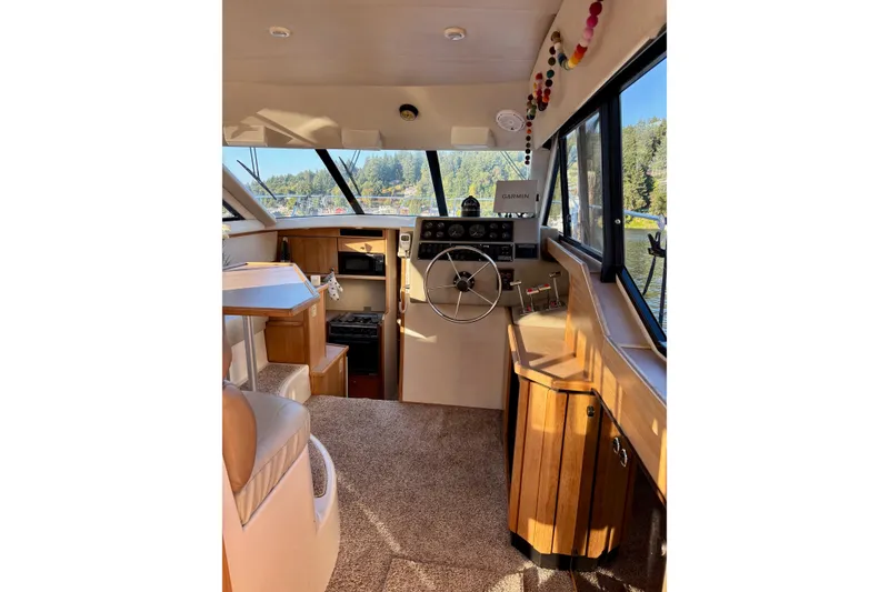 Slide: The Image of 1998 Bayliner 3388 Command Bridge Motoryacht interior with helm, seating, and navigation equipment. - 16