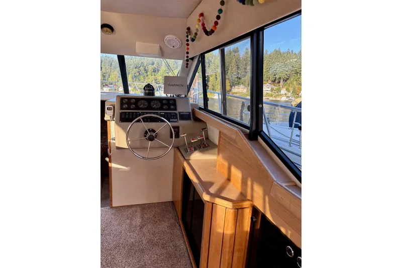 Slide: The Image of 1998 Bayliner 3388 Command Bridge Motoryacht helm with steering wheel and navigation equipment. - 17