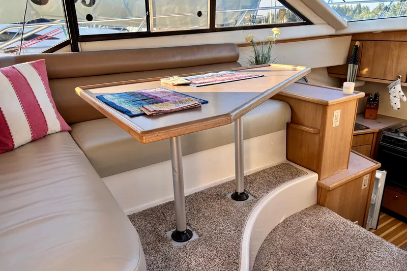 Slide: The Image of Interior of 1998 Bayliner 3388 Command Bridge Motoryacht with cozy seating and table. - 19