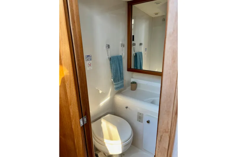 Slide: The Image of Bathroom interior of 1998 Bayliner 3388 Command Bridge Motoryacht with mirror and towel. - 28