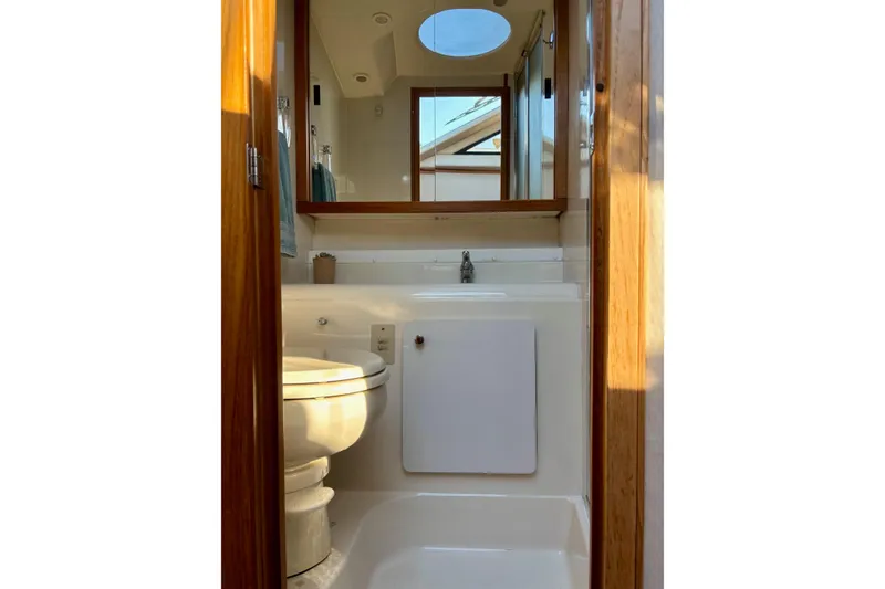 Slide: The Image of Bathroom interior of 1998 Bayliner 3388 Command Bridge Motoryacht, featuring toilet and sink. - 29