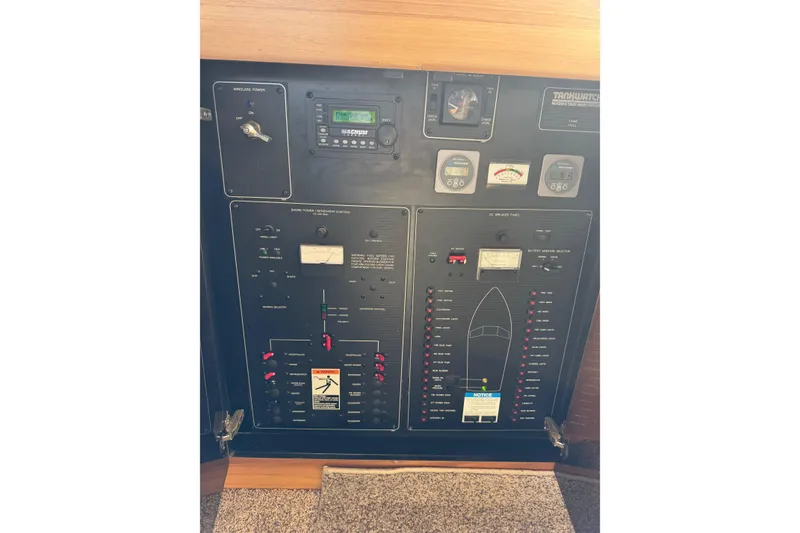 Slide: The Image of 1998 Bayliner 3388 Command Bridge Motoryacht control panel with gauges and switches. - 33