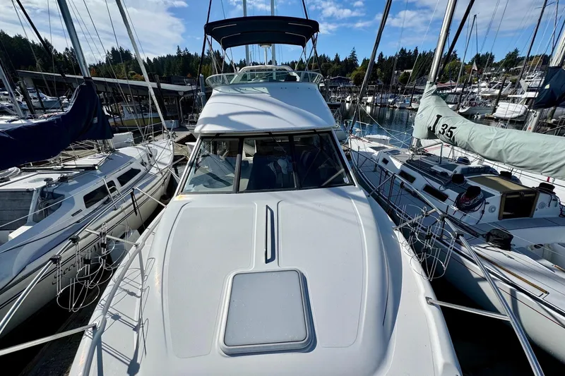 Slide: The Image of 1998 Bayliner 3388 Command Bridge Motoryacht docked among sailboats in a marina. - 4