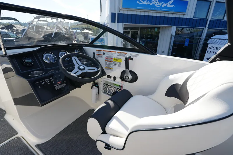 Slide: The Image of 2023 Bayliner VR5 Bowrider I/O cockpit with steering wheel and comfortable seating. - 12