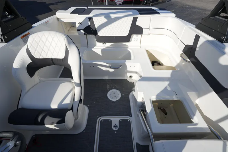 Slide: The Image of 2023 Bayliner VR5 Bowrider I/O interior with white seating and storage compartments. - 16