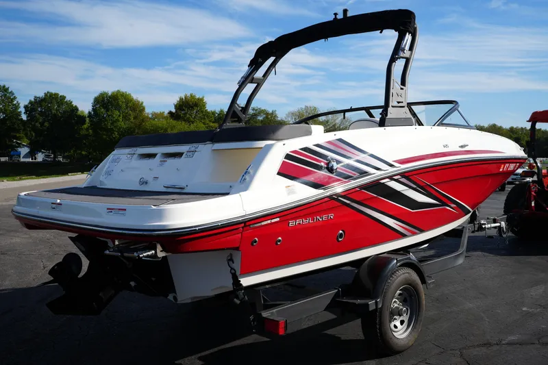 Slide: The Image of 2023 Bayliner VR5 Bowrider I/O in vibrant red, parked outdoors on a trailer. - 4