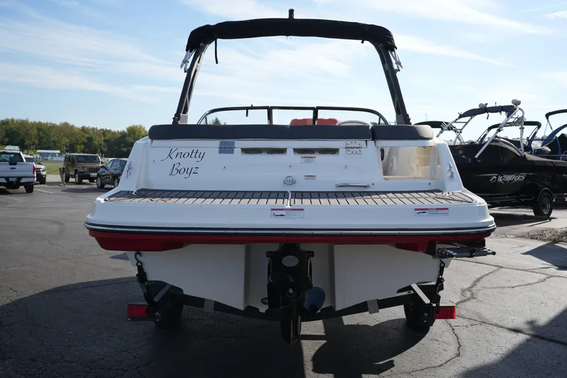 Slide: The Image of 2023 Bayliner VR5 Bowrider I/O boat, rear view, parked on pavement. - 5