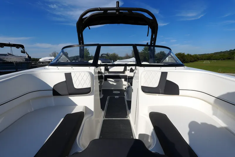Slide: The Image of 2023 Bayliner VR5 Bowrider I/O with sleek interior and spacious seating under clear blue sky. - 9