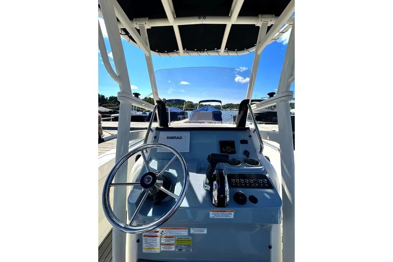 Slide: The Image of 2023 Bayliner Trophy T22CC boat console with steering wheel and controls. - 17