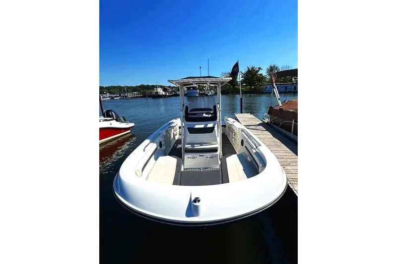 Slide: The Image of 2023 Bayliner Trophy T22CC boat docked on a sunny day. - 2