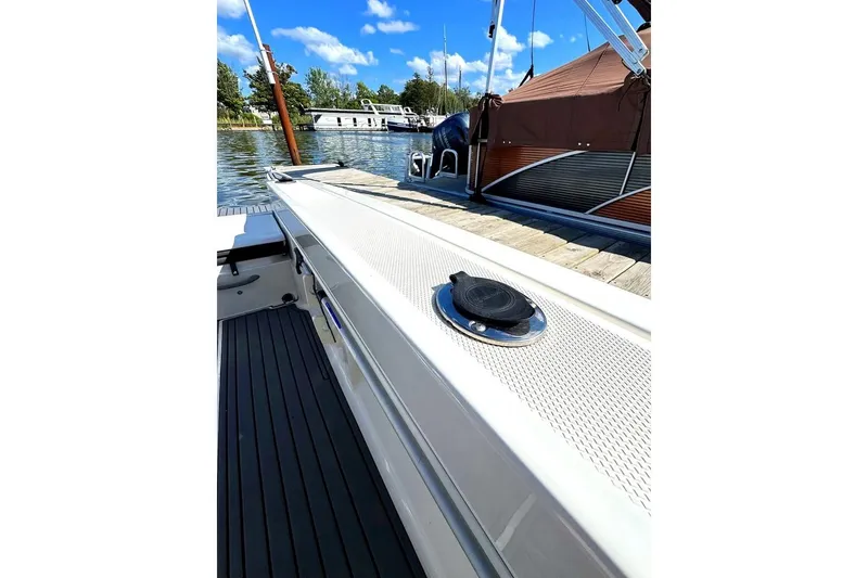 Slide: The Image of 2023 Bayliner Trophy T22CC boat docked, showcasing sleek design and modern features. - 21