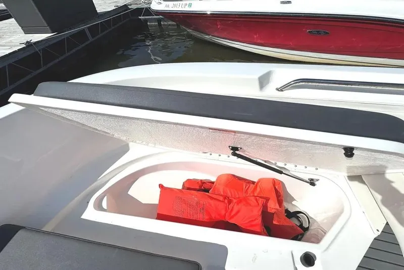 Slide: The Image of 2023 Bayliner Trophy T22CC boat storage compartment with life jackets. - 28