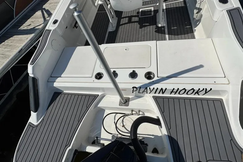 Slide: The Image of 2023 Bayliner Trophy T22CC boat deck with "Playin Hooky" text. - 31