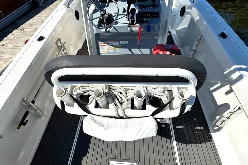 Slide: The Image of 2023 Bayliner Trophy T22CC boat interior with rod holders and steering console. - 32