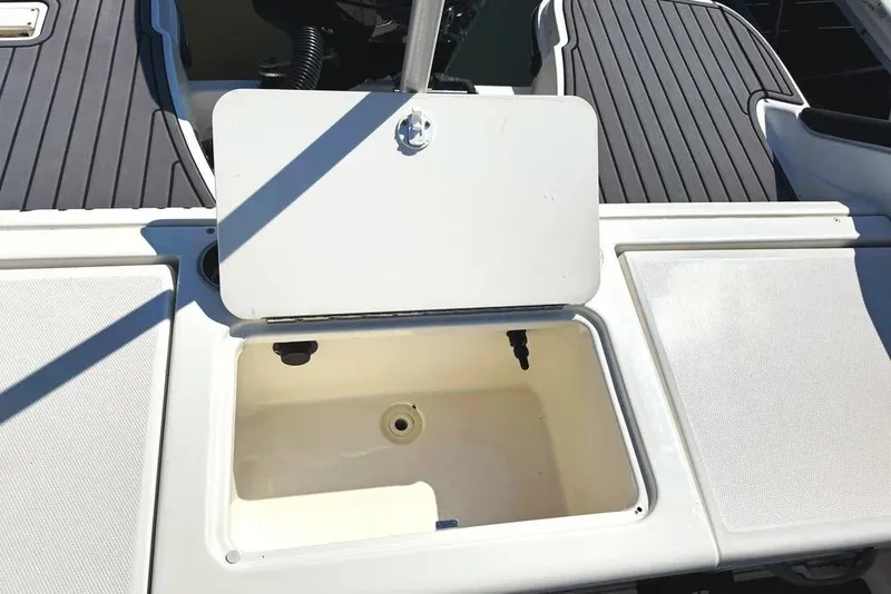 Slide: The Image of 2023 Bayliner Trophy T22CC boat with open storage compartment on deck. - 33
