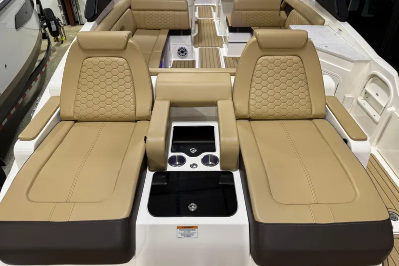 Slide: The Image of 2023 Sea Ray SDX 290 boat interior with luxurious tan seating and modern design. - 12