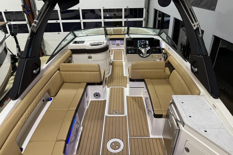Slide: The Image of Luxurious 2023 Sea Ray SDX 290 boat interior with tan seating and modern dashboard. - 13