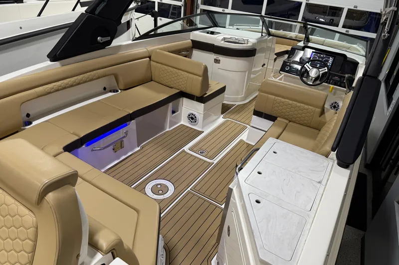 Slide: The Image of 2023 Sea Ray SDX 290 boat interior with tan seating and modern dashboard. - 14