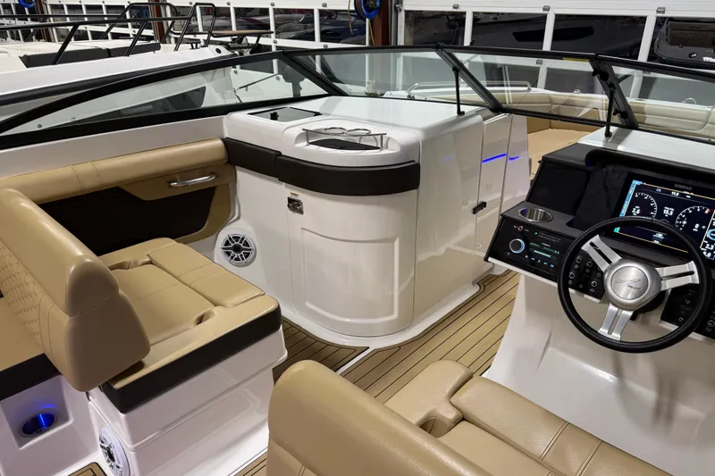 Slide: The Image of 2023 Sea Ray SDX 290 boat interior with beige seating and modern dashboard. - 15