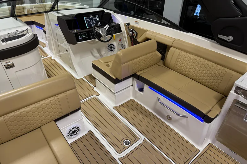 Slide: The Image of 2023 Sea Ray SDX 290 boat interior with tan seating and modern dashboard. - 17