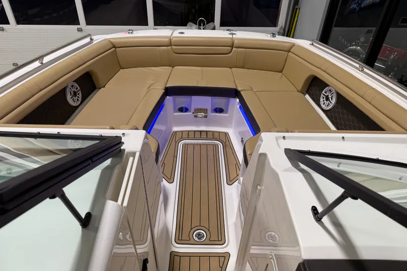 Slide: The Image of 2023 Sea Ray SDX 290 boat interior with tan seating and blue accent lighting. - 21