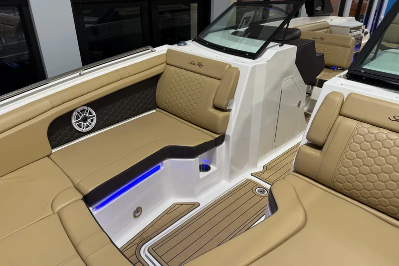 Slide: The Image of 2023 Sea Ray SDX 290 boat interior with tan seating and modern design. - 23