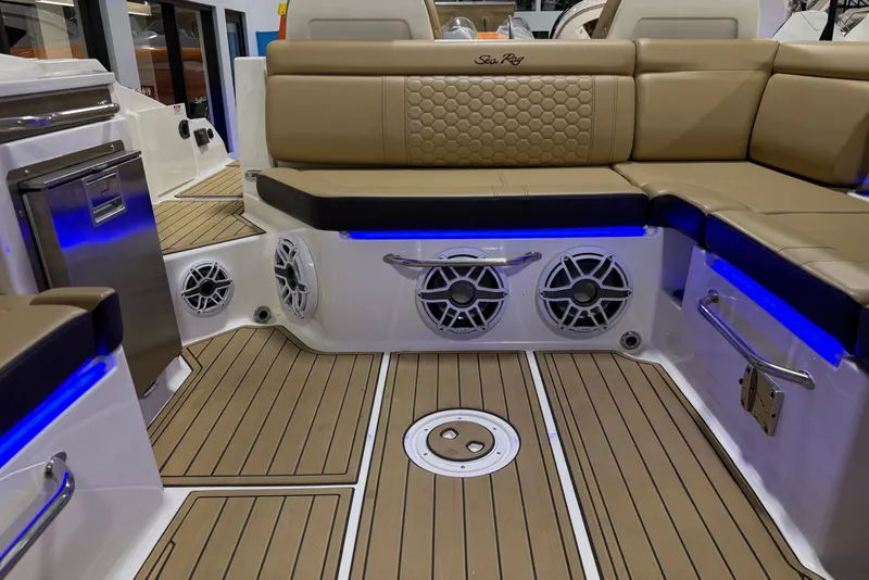 Slide: The Image of Luxurious interior of 2023 Sea Ray SDX 290 boat with tan seating and blue LED lighting. - 26