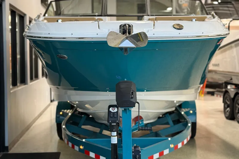 Slide: The Image of 2023 Sea Ray SDX 290 boat on trailer, displayed indoors. - 3
