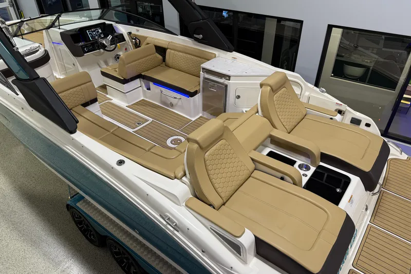 Slide: The Image of 2023 Sea Ray SDX 290 boat interior with luxurious tan seating and modern dashboard. - 6