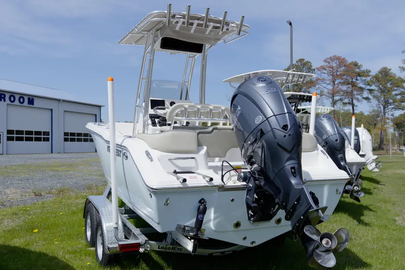 Slide: The Image of 2026 Key West 203 FS boat on trailer, featuring powerful outboard motor. - 13