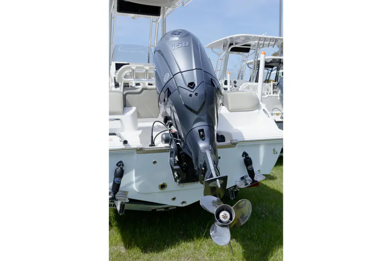 Slide: The Image of 2026 Key West 203 FS boat with powerful outboard motor, displayed on grass. - 14