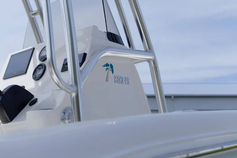 Slide: The Image of 2026 Key West 203 FS boat console with gauges and logo, under clear sky. - 15
