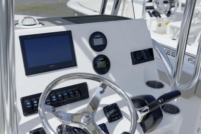 Slide: The Image of Steering console of 2026 Key West 203 FS boat with modern controls and navigation display. - 17