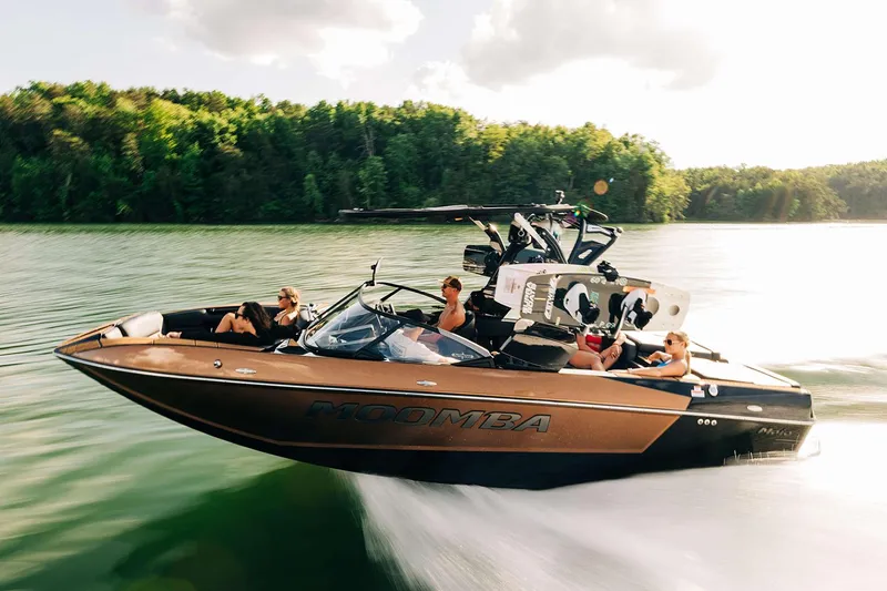 Slide: The Image of Manufacturer Provided Image: 2025 Moomba Mojo boat cruising on a lake with passengers enjoying the ride. - 12