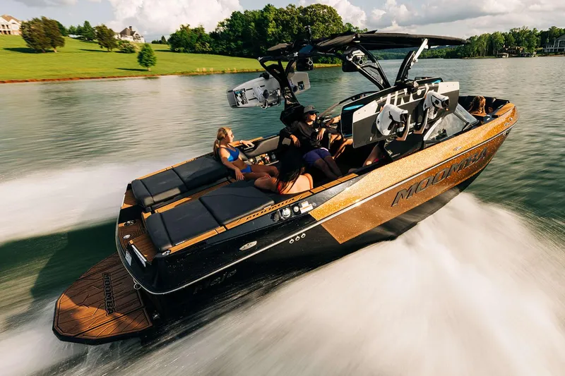 Slide: The Image of Manufacturer Provided Image: 2025 Moomba Mojo boat cruising on a lake with passengers enjoying the ride. - 13