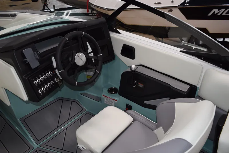 Slide: The Image of 2025 Moomba Mojo boat interior with modern dashboard and steering wheel design. - 16